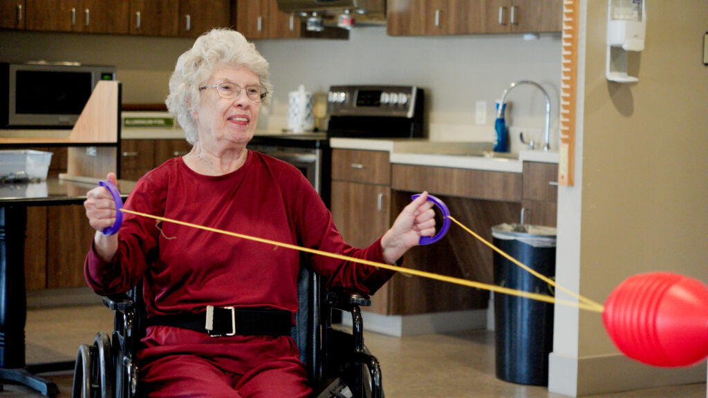 A woman goes through physical therapy at a short term care facility