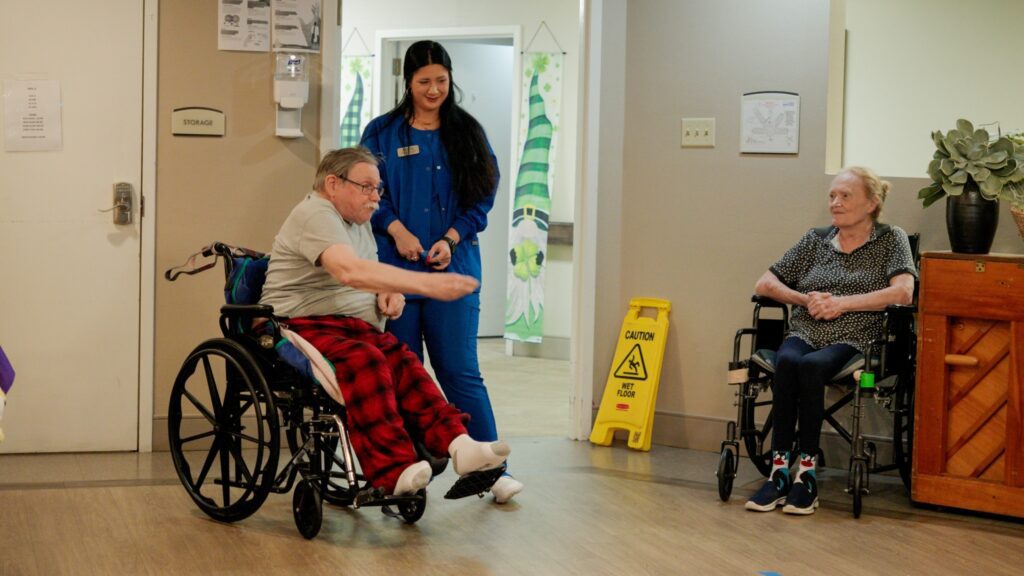 A man playing a game at a skilled nursing facility